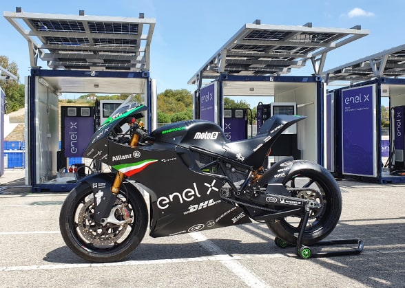 MotoEElectric motorbike in the foreground with charging infrastructure behind