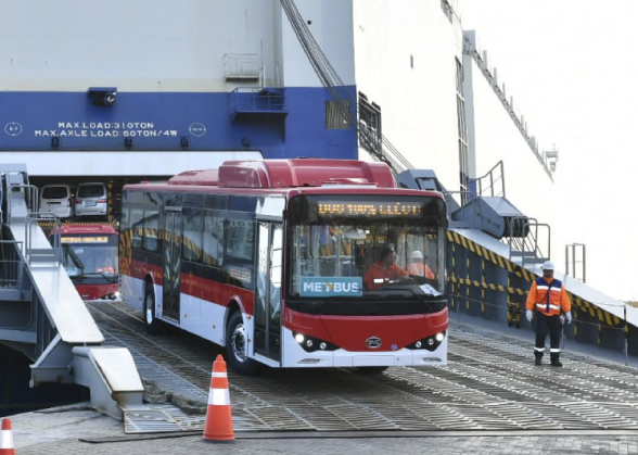 Electric bus disembarking from a ship